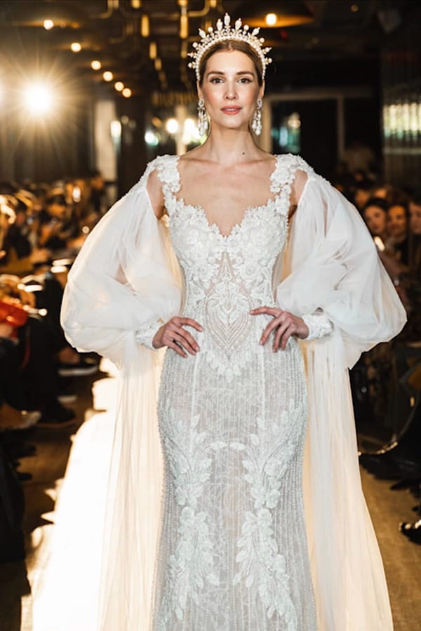A model in a white dress on the runway
